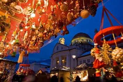 a christmas market in front of a building with christmas decorations at Residence Désirée Classic & Design in Merano