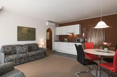 a living room with a couch and a table at Residence Désirée Classic & Design in Merano
