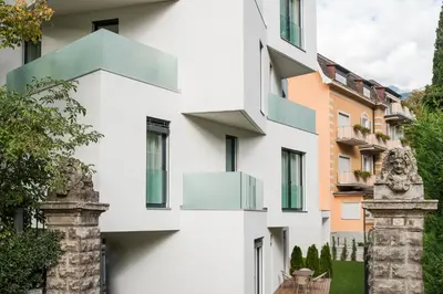 a white building with balconies on the side of it at Residence Désirée Classic & Design in Merano