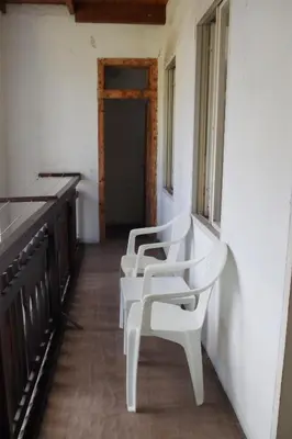 a row of white chairs sitting in a room at Da Francesca in Fiera di Primiero