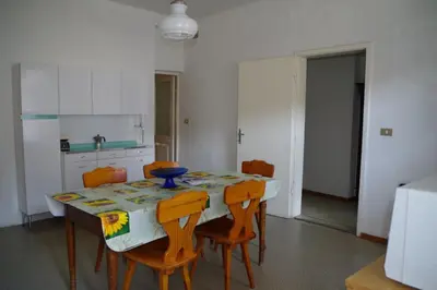 a kitchen with a table with chairs and a table and a kitchen at Da Francesca in Fiera di Primiero