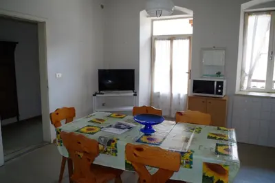 a dining room with a table and four chairs at Da Francesca in Fiera di Primiero