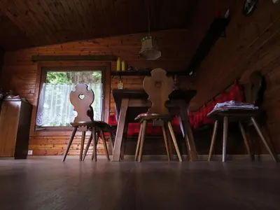 two wooden chairs sitting at a table in a room at Chalet San Valentino in Salorno sulla Strada del Vino