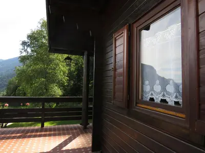 a window on the side of a house with a view at Chalet San Valentino in Salorno sulla Strada del Vino