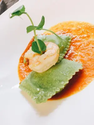 a plate of food with a piece of shrimp on top at Genusshotel Diamant in Naturno