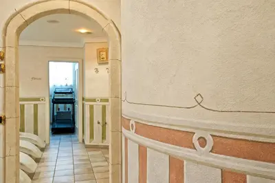 a bathroom with a row of sinks in a room at B&B Garni Serena in Arabba