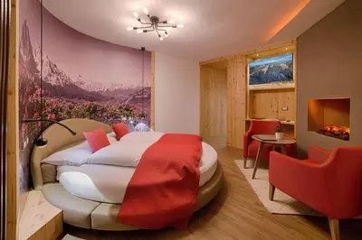 a hotel room with a bed and a table and chairs at Active Hotel Malita in Arabba
