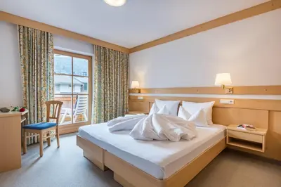 a hotel room with a bed and a window at Residence Sonnwies in Valdaora