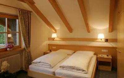 a bedroom with two beds and a window at Residence Sonnwies in Valdaora