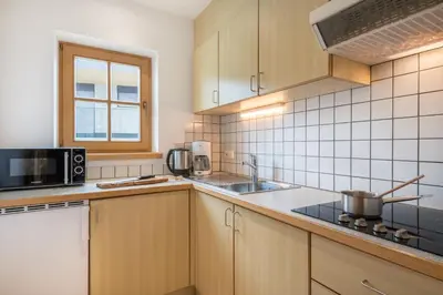 a kitchen with a sink and a microwave at Residence Sonnwies in Valdaora