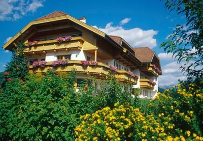 a house with flowers on the side of it at Residence Sonnwies in Valdaora