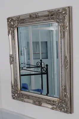 a mirror with a reflection of a table in it at Ferienwohnungen Villa Mirabilis in Rablà