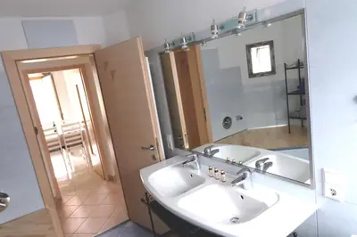 a bathroom with a sink and a mirror at Ferienwohnungen Villa Mirabilis in Rablà