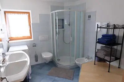 a bathroom with a shower and a sink and a toilet at Ferienwohnungen Villa Mirabilis in Rablà