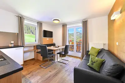 a living room with a couch and a table at Jaiterhof in Funes