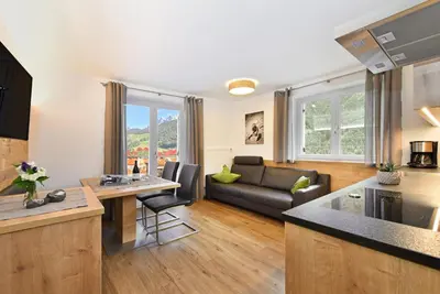 a kitchen and living room with a couch and a table at Jaiterhof in Funes
