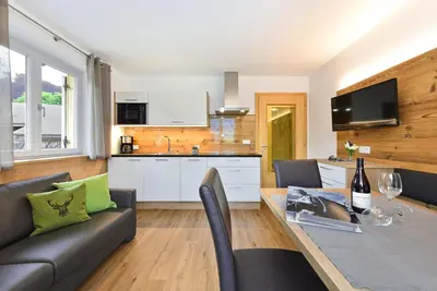 a living room with a couch and a table at Jaiterhof in Funes