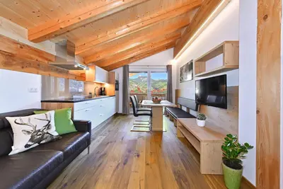 a living room with a couch and a table at Jaiterhof in Funes