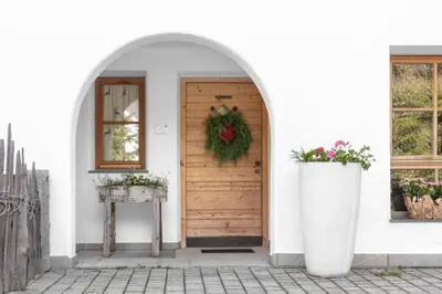 a front door with a christmas wreath on it at Chalet Ciasa Tino & Sara - BelaVal Apartments in Corvara in Badia