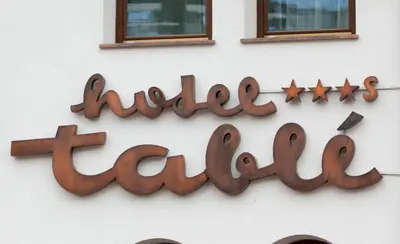 a sign on the side of a building at Hotel Table in Corvara in Badia