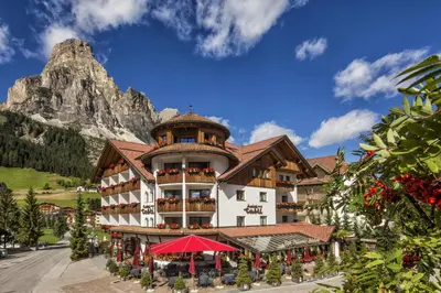 a hotel with a mountain in the background at Hotel Table in Corvara in Badia
