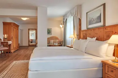 a large white bed in a hotel room at Hotel Table in Corvara in Badia