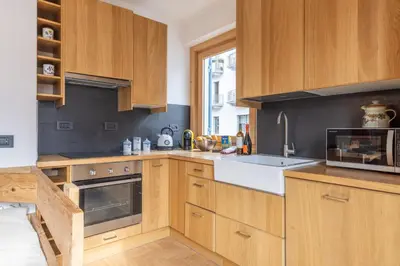 a kitchen with wooden cabinets and a microwave at Casa Olimpia in Cortina dʼAmpezzo
