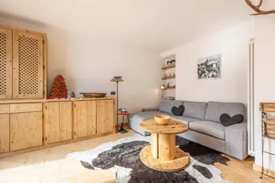 a living room with a couch and a table at Casa Olimpia in Cortina dʼAmpezzo