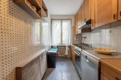 a small kitchen with a sink and a dishwasher at Casa Alverà in Cortina dʼAmpezzo