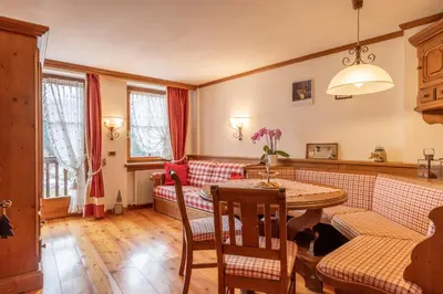 a living room with a couch and a table at Casa Do Sol in San Vito di Cadore