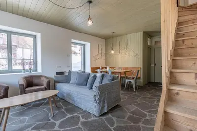 a living room with a couch and a table at Casa Majon in Cortina dʼAmpezzo
