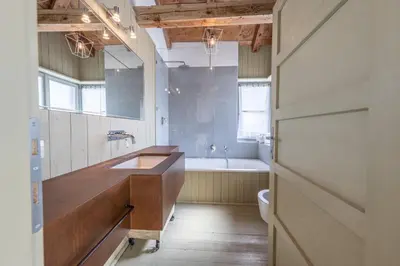 a bathroom with a sink and a bath tub at Casa Majon in Cortina dʼAmpezzo