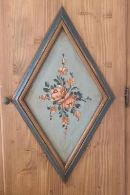 a picture of a painting of flowers on a wall at Casa Pecol in Cortina dʼAmpezzo