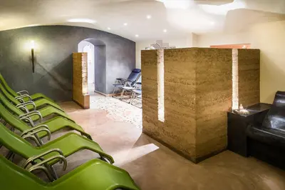 a group of green chairs in a waiting room at Garnì Sirio in Colfosco