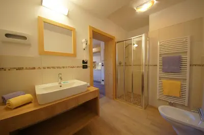 a bathroom with a sink and a shower at Garnì Sirio in Colfosco