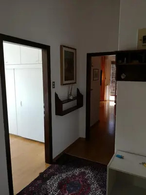 a living room with a mirror and a hallway at Spazioso e accogliente nel centro di Merano in Merano