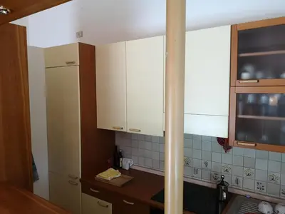 a kitchen with white cabinets and a counter top at Spazioso e accogliente nel centro di Merano in Merano