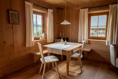 a dining room with a wooden table and chairs at Appartamenti Sotgherdena in Badia