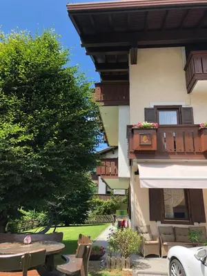 a building with a patio with a table and a tree at Villa Tisot in Siror