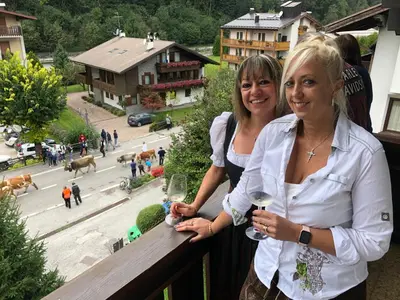 two women standing on a balcony with glasses of wine at Villa Tisot in Siror