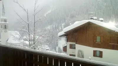 a house with snow on the roof of it at Freetime PinkAlps in Arabba