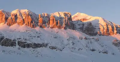 a snow covered rocky mountain with snow on it at Freetime PinkAlps in Arabba