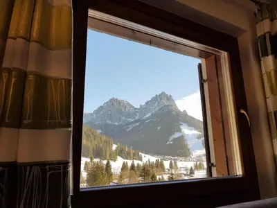 a window in a room with a view of a mountain at Residence La Zondra in Pozza di Fassa