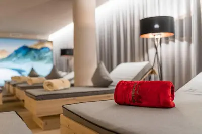 a room with couches and a red bag on a table at Hotel Schönblick in Maranza