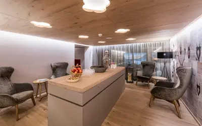 a waiting room with chairs and a reception counter at Hotel Schönblick in Maranza