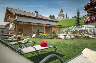 a row of lawn chairs sitting in a yard at Hotel Schönblick in Maranza