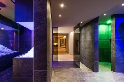 a hallway of a house with blue and green lights at Hotel Schönblick in Maranza
