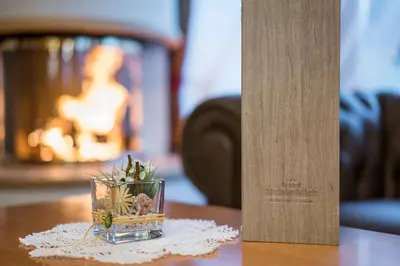 a small glass vase with a plant in it on a table at Hotel Schönblick in Maranza