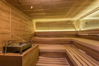 an empty sauna with wooden walls and wooden floors at Hotel Schönblick in Maranza