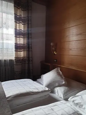 a bedroom with two beds and a window at Garni Le Chalet in Santa Cristina in Val Gardena